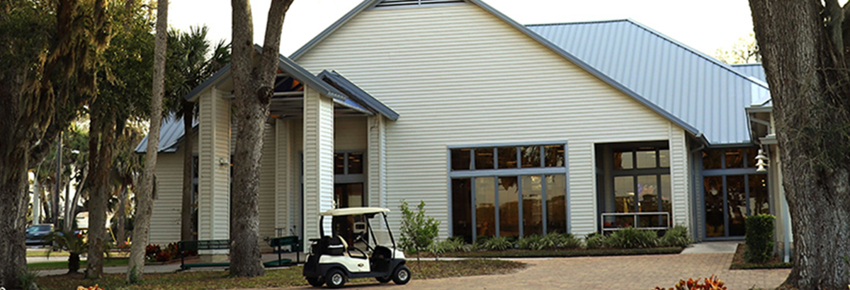view of golf clubhouse with cart in front